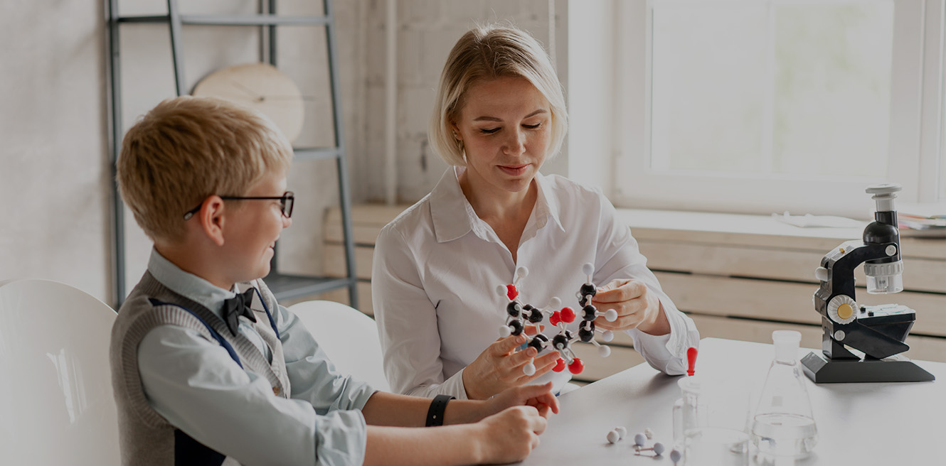 Female science tutor in Orlando studying chemistry with student